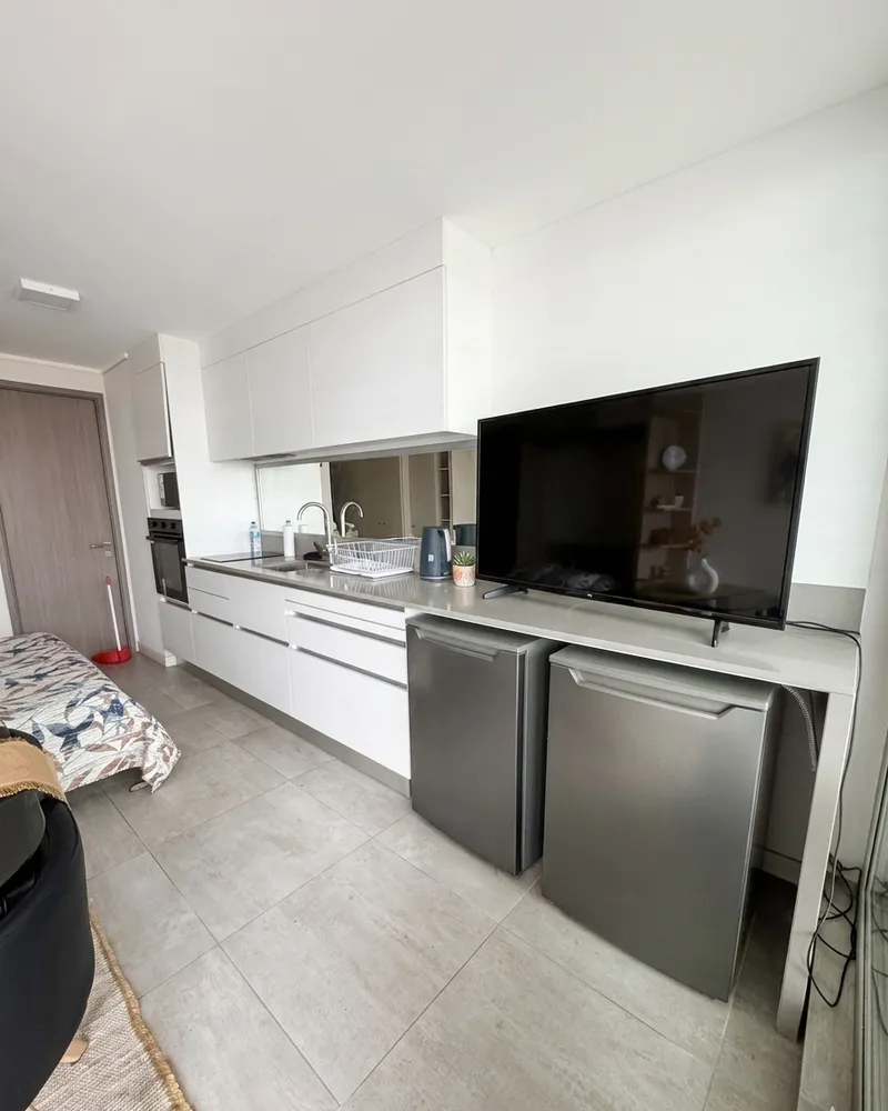 Televisor y frigobares junto a la cocina